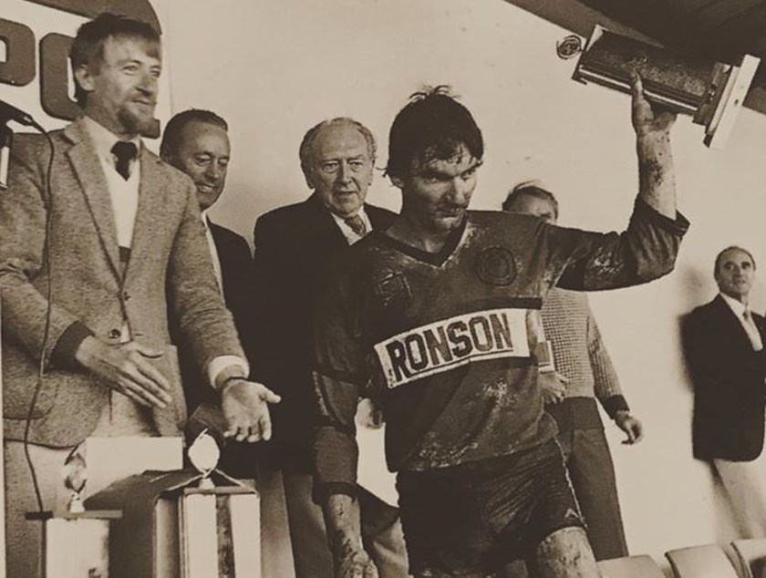 David Hatch holds the trophy aloft after the 1986 Orange Sevens tournament.